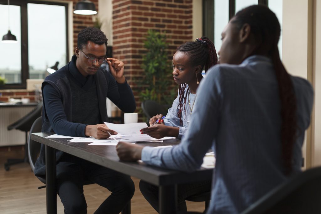 African american research agency coworkers in meeting about startup project financial status.